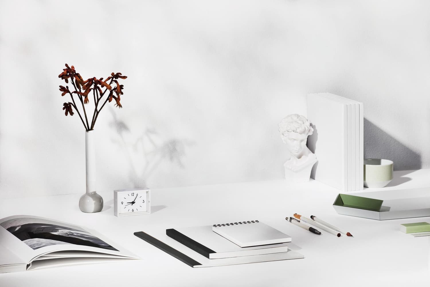 Pale sculptural objects on a light background